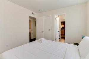 a white bedroom with a large white bed at 5 Bedroom Charmer in Granada Hills in Granada Hills