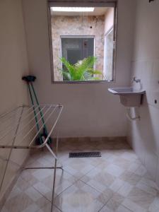 a bathroom with a sink and a window at casa ana centro in Caraguatatuba