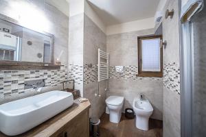 a bathroom with a white sink and a toilet at Domus Antica Aosta in Aosta