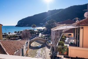 a view of a town with a bridge and the ocean at Noliday Riviera Sea View Luxury Apartment in Noli