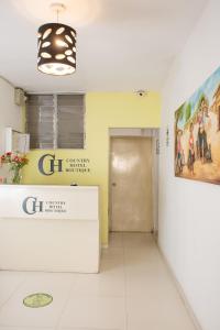 a waiting room with a reception desk and a painting at Hotel Country Boutique in Piura +16 photos