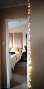 a bedroom with a bed with lights on the wall at 24 Park Views for Holidays or Short Breaks please no commercial vans thank you in High Hesket