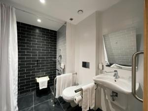 a bathroom with a sink and a toilet and a mirror at Holiday Inn Express - Ankara - Airport by IHG in Ankara
