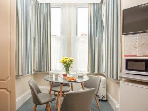 a small dining room with a table and chairs at Apartment Two - Uk39835 in Paignton