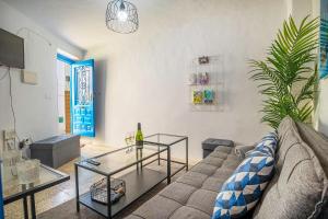 a living room with a couch and a glass table at Casa Corbeto 7 in Cómpeta