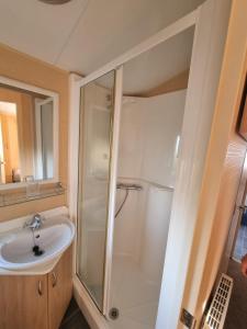 a bathroom with a shower and a sink at The Perrycroft at The Beeches Caravan Park in Gilcrux