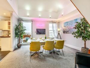 a dining room with a table and chairs at Walpole Heights Penthouse in Margate