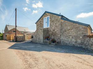 a stone house with a window on the side of it at The Hayloft - Uk40092 in Bryngwyn