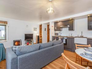 a living room with a couch and a kitchen at Herons Rest in Glendale