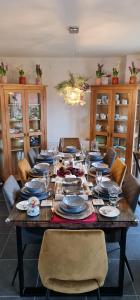 a dining room table with plates and wine glasses at Magnolia House in Nantwich