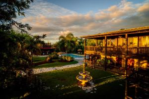 a house with a fountain in front of a yard at Hacienda el Jibarito in San Sebastian