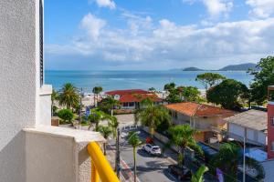 a view of the ocean from the balcony of a building at Boulevard Beach Canasvieiras Hotel in Florianópolis