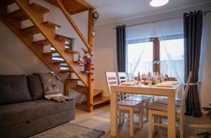 a living room with a table and a couch at Domki JAWOR in Zakopane