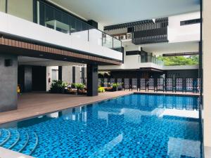 a swimming pool in the middle of a building at Mae Phim Escape Beachfront Apartments in Mae Pim