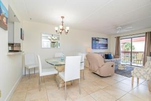 a dining room and living room with a table and chairs at 3203 Near Ocean 2nd Floor NW in Saint Augustine Beach