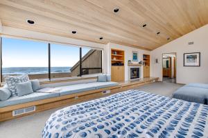 a bedroom with a large bed and a large window at The Indigo in Sea Ranch