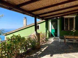 a green house with a wooden roof at Villa Pietrafiore in Monterosso al Mare