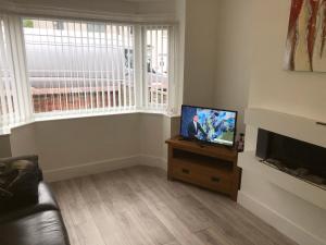 a living room with a flat screen tv and a couch at Shepherds retreat in Balby
