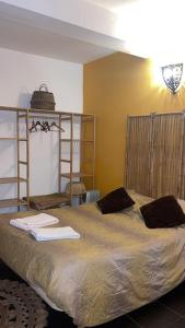 a bedroom with a large bed with towels on it at Porto Riad - Guest House in Porto