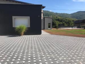 a black house with a plant in front of it at Villa Nature in Sarajevo