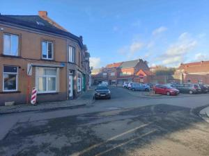 a street with cars parked on the side of the road at Bel appartement confortable Mons in Mons