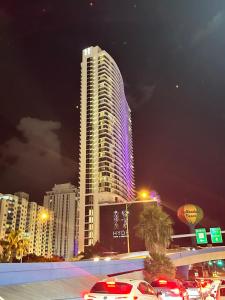 a tall building with lights on it at night at Hyde Resort Oceanview Luxurious 2-Bedroom PH 6Pax in Hollywood