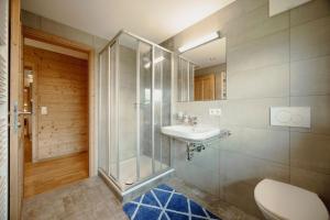 a bathroom with a shower and a sink and a toilet at Bauernhof Unterbichl in Flachau