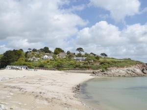 a view of a beach with houses on a hill at Roland Cottage in Falmouth