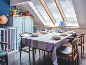 a dining room with a table with chairs and a skylight at Linstead House in Kendal