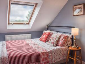 a bedroom with a bed and a window at Linstead House in Kendal