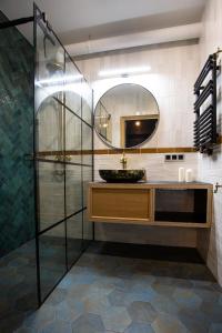 a bathroom with a sink and a mirror at Sunny Apartment Lwowska 10 in Kraków