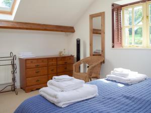 a bedroom with two beds with white towels on them at Barn Cottage in Talley