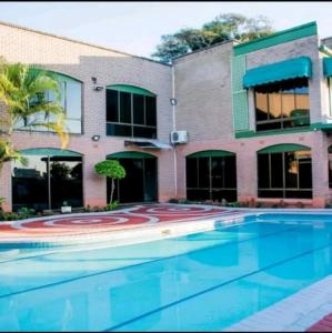 a large swimming pool in front of a building at Palm View Apartment in Pretoria