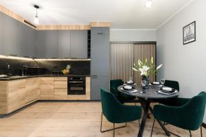 a kitchen and dining room with a table and chairs at Tumsky14 in Poznań