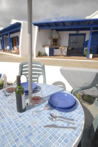 a table with a bottle of wine and glasses on it at Punta mujeres casitas del mar in Arrieta