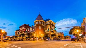 a large building with a tower on a city street at Windsor Hotel, Ascend Hotel Collection in Americus