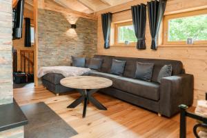 a living room with a couch and a table at Fichtelchalet Bischofsgrün in Bischofsgrün