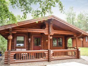 a log cabin with a porch and a deck at Felmoor Park - Mystic Falls in Felton