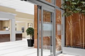an office lobby with glass doors and plants at Hampton Inn Manhattan Times Square North in New York