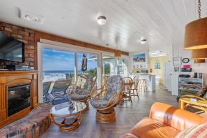 a living room with a couch and chairs and a fireplace at Coastal Coziness in Cayucos