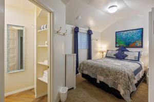 a small bedroom with a bed and a mirror at Coastal Coziness in Cayucos