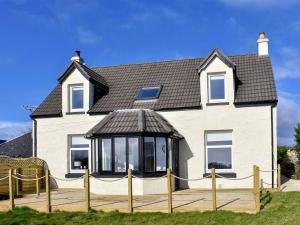 a large white house with a large gazebo at Loanmhor in Kilmory