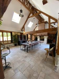 a large room with tables and chairs in a building at Gîte Normand 26 couchages in Rai-sur-Rîle