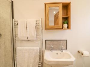 a white bathroom with a sink and a mirror at Bluebell in Swadlincote +11 photos