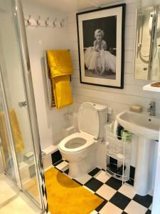 a bathroom with a toilet and a sink at Ibiza Casa in Kent