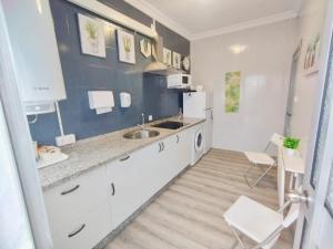 a kitchen with a sink and a refrigerator at Apartamento Ana Maria in San Juan del Puerto