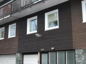 a black house with white windows and a balcony at Treetops in Bowness-on-Windermere