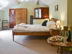 a bedroom with a bed and a table with wine glasses at Croyde - Ukc3785 in West Down