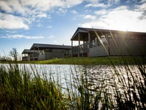 two houses on a hill next to a body of water at Silver Birch - Ukc4529 in Darsham