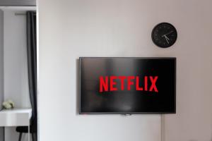 a television with the netflix sign on a wall at Le Cocon - 5 min RER A - 10 min Paris in Fontenay-sous-Bois